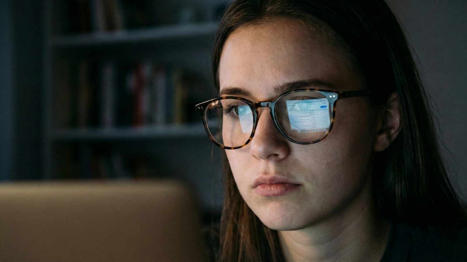 Graduate looking at a blurred job rejection email on a laptop screen